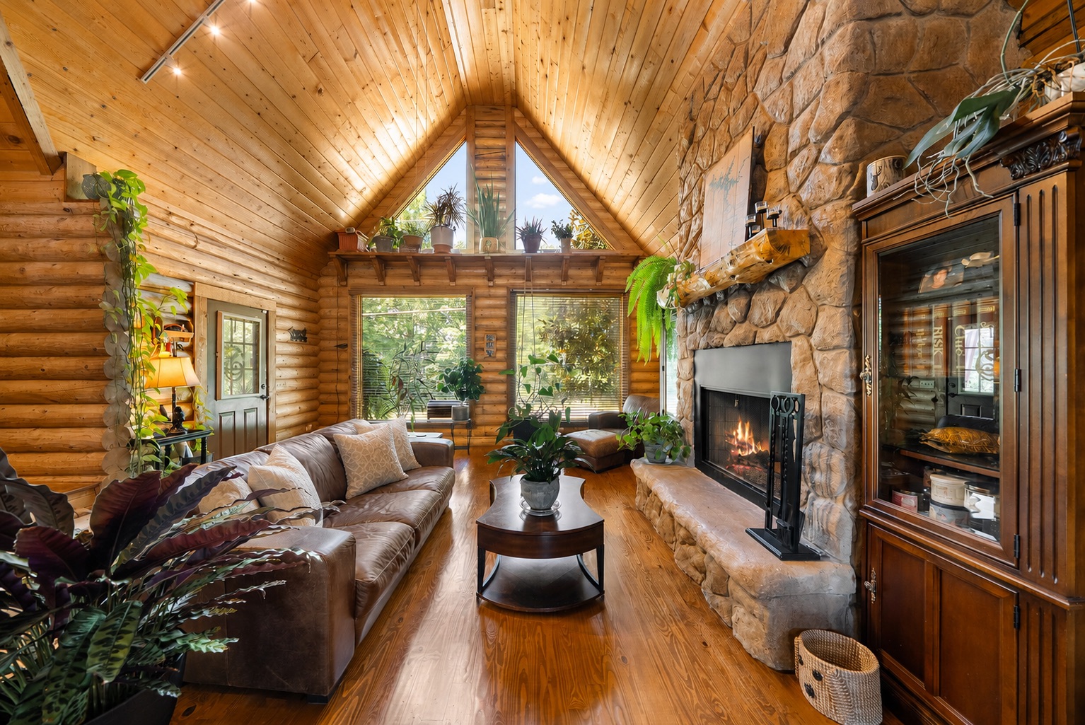Great room facing the stone fireplace and cathedral windows